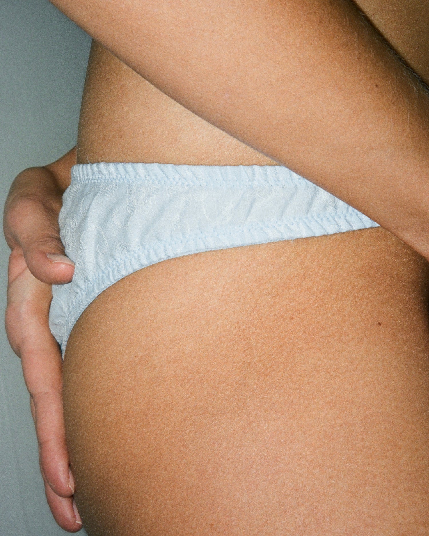 Blue cotton panties with lace on a model.